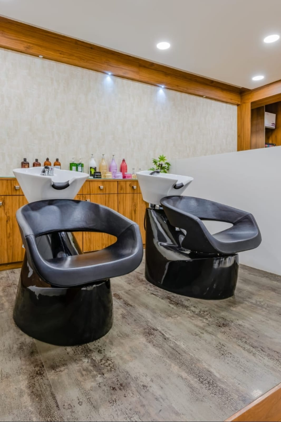 Wash lounge with sculptural chairs at Scissors & Comb